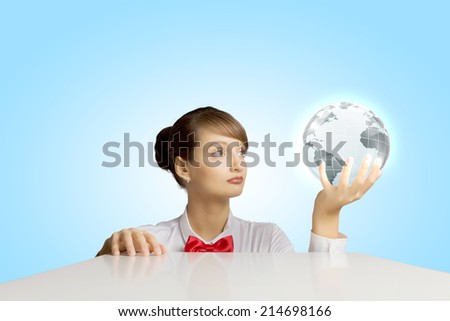 Young woman holding digital Earth planet in hand