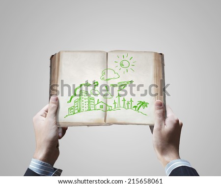 Close up of businessman hands holding opened book with sketches
