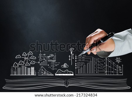 Close up of hand drawing business sketches on cement wall