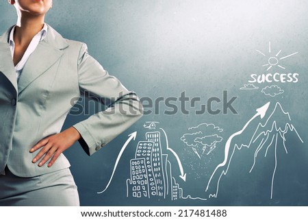 Close up of businesswoman and business sketches on cement wall