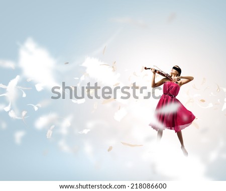 Pretty lady in red dress playing violin