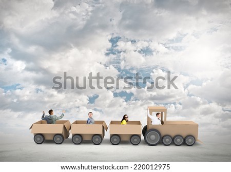 Business people riding carton train. Teamwork concept