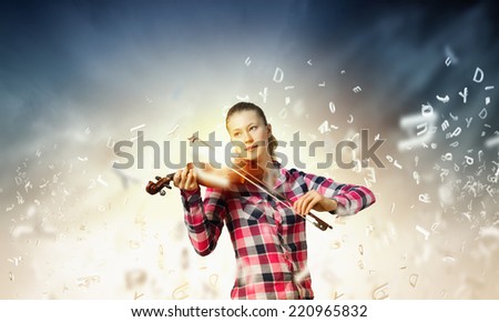 Young pretty girl in casual playing violin