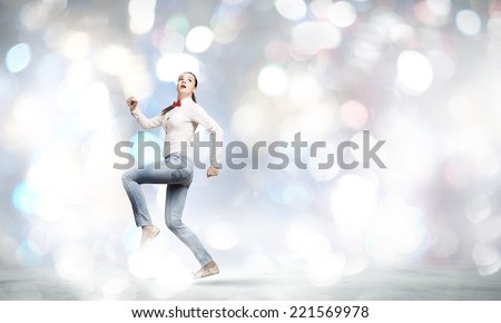 Young funny pretty woman in jeans running in a hurry