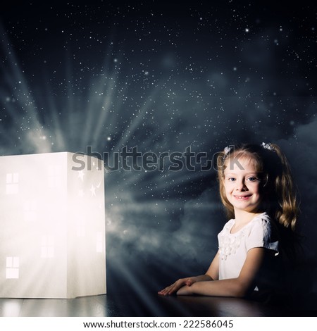 Little cute girl in darkness dreaming about home and family