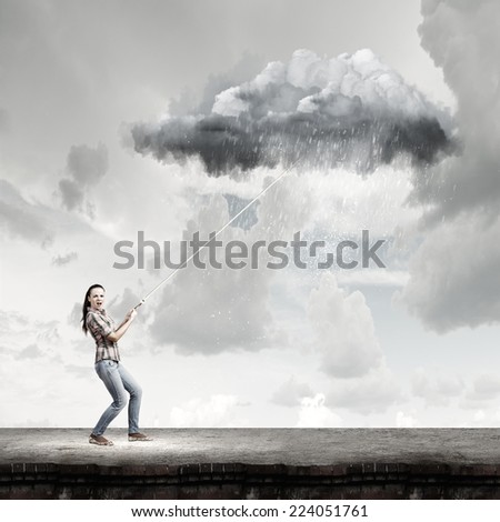 Young woman in casual catching cloud with rope