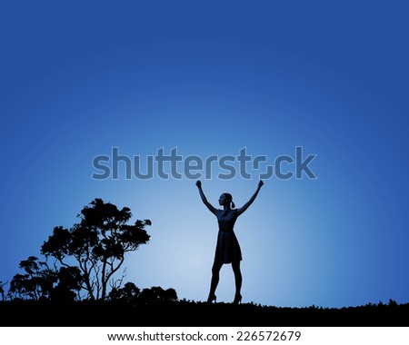 Silhouette of woman in dress at night with hands up