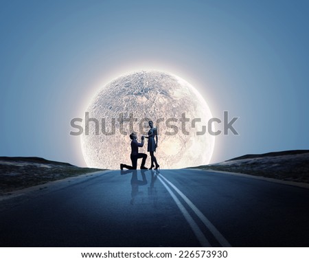 Silhouettes of romantic couple under the moon light