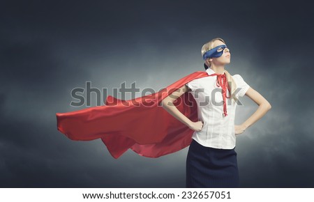 Young confident woman in red cape and mask Foto d'archivio © 