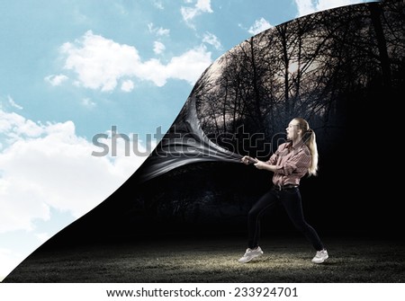 Young woman pulling page to change scene