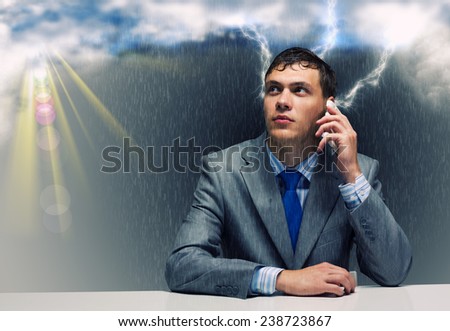 Young troubled wet businessman talking on phone