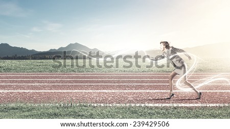 Young businesswoman in start position ready to run