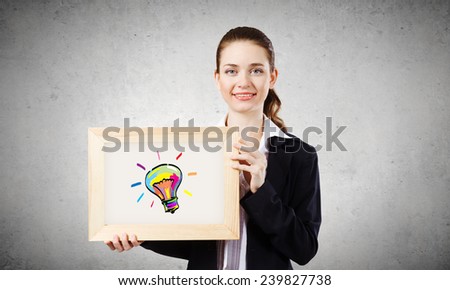 Young woman showing wooden frame with drawn bulb