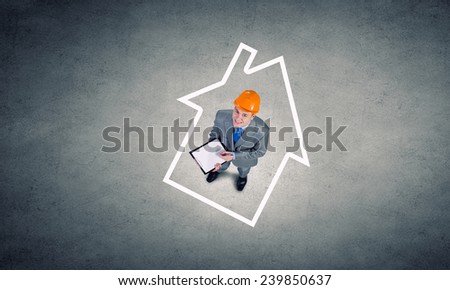 Top view of businessman and business sketches on floor