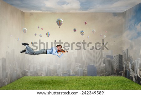 Businessman flying in sky and playing violin