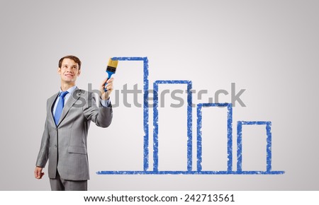 Handsome businessman with paint brush in hand