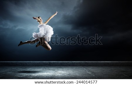 Young girl dancer jumping high in sky