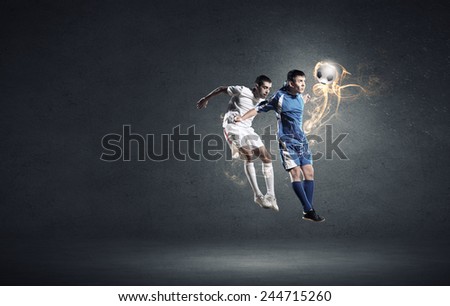 Two football players in jump fighting for ball