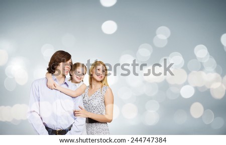Happy family of mother father and daughter against bokeh background