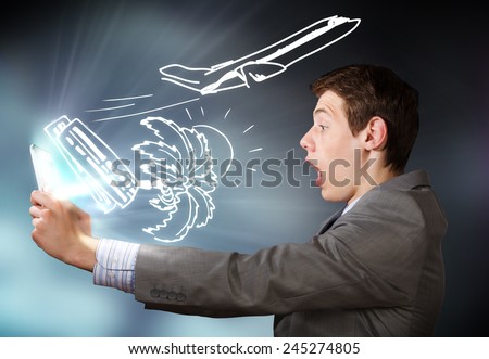 Young emotional businessman looking shocked in tablet pc