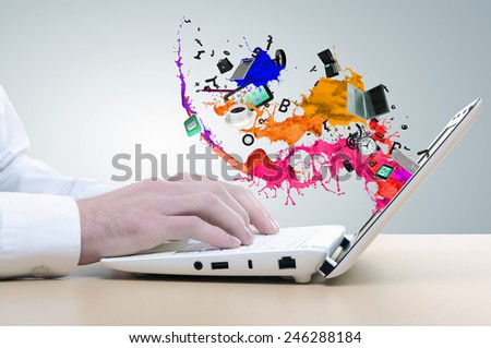Close up of man\'s hands using laptop and splashes out of monitor