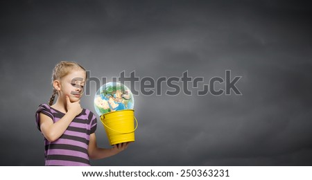 Cute girl looking at Earth planet in her bucket. Elements of this image are furnished by NASA