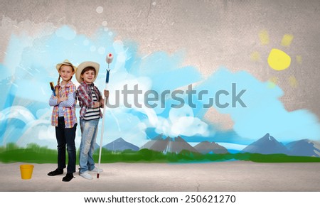 Two children of school age painting wall in colors