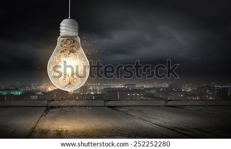 Conceptual image with light bulb and gears inside