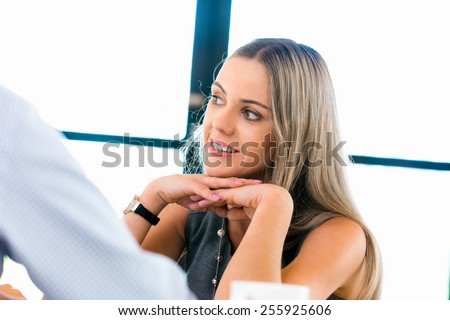 Young businesswoman listening to someone
