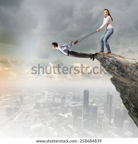 Young man on lead of woman trying to escape