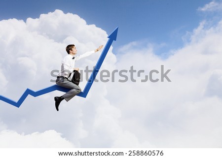 Young businessman riding graph arrow going up
