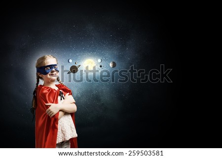 Cute girl in super hero costume exploring space system