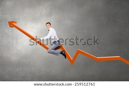 Young businessman riding graph arrow going up