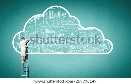 Rear view of businesswoman standing on ladder and reaching cloud