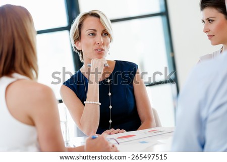 Businesswoman having discussion with collegues