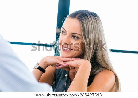 Young businesswoman listening to someone