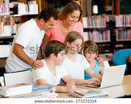 Family in library with books
