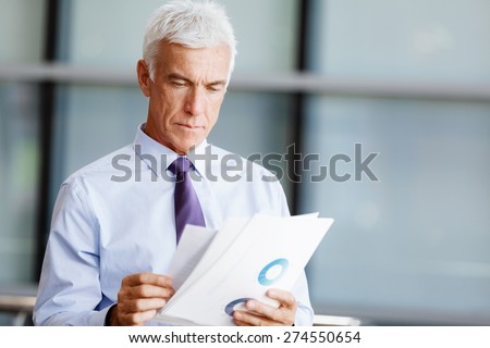 Businessman in office working with papers