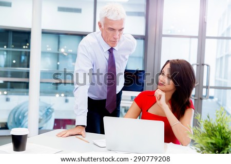 Businessman and young female employee in office
