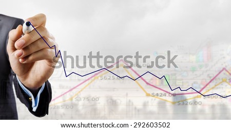 Close up of businessman drawing increasing graph with marker