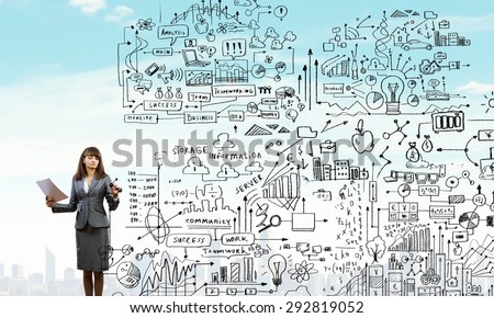 Full body of businesswoman drawing sketches of business strategy