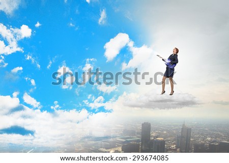 Cheerful businesswoman on cloud playing electronic guitar