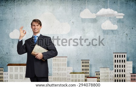 Young handsome man in suit reading old book