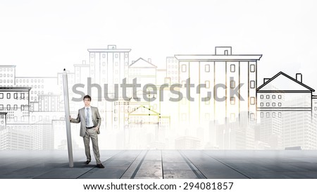 Young man architecture designer with huge pencil