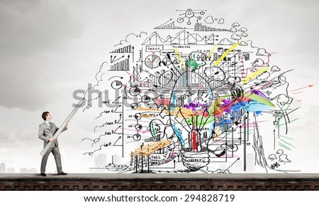Businessman drawing plan strategy success with huge pencil
