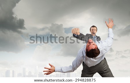 Two businesspeople in anger fighting with each other