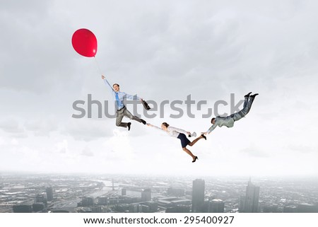 Business people flying in the sky on air balloon