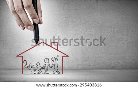 Close up of human hand drawing happy family and real estate concept