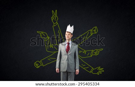 Young man with many drawn hands behind back
