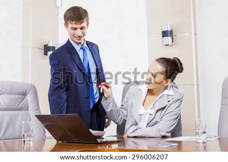 Young businessman showing lady boss business documents